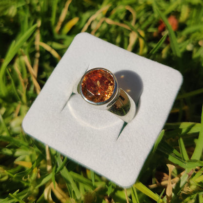 Solitaire synthetic diamond ring in Silver with a green grass background